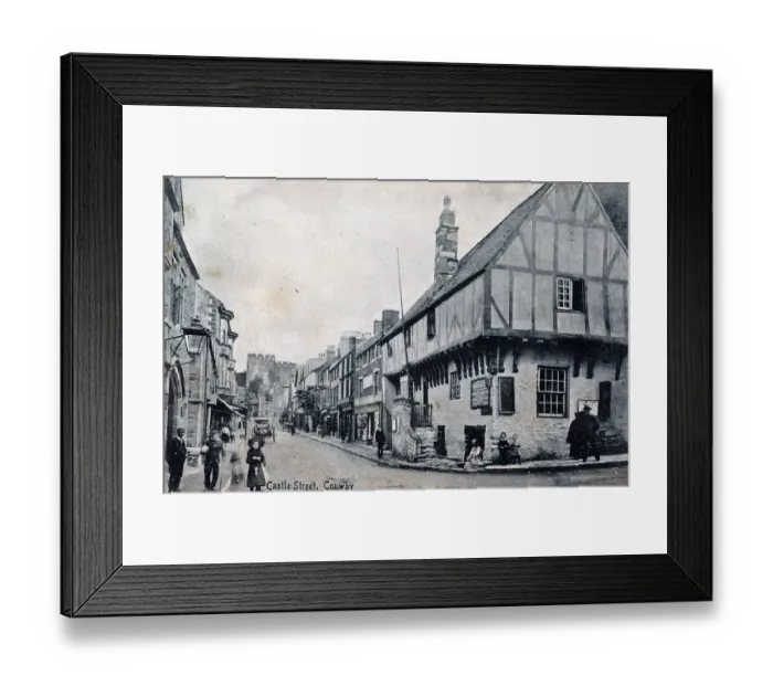 Framed Print : Castle Street, Conway, with timbered houses and castle Framed Print : Castle Street, Conway, with timbered houses and castle