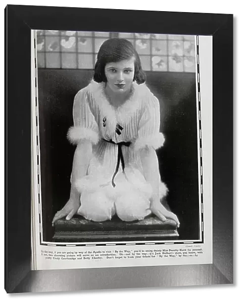 Dorothy Hurst, actress, theatrical studio portrait, kneeling, in pale costume with down trim. Captioned, Just By the Way!'. With description, By the way, if you are going by way of the Apollo to visit 'By the Way