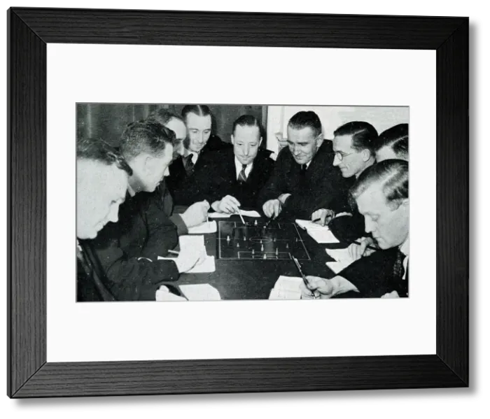 Framed Print : Football referees studying the rules of the game Framed Print : Football referees studying the rules of the game