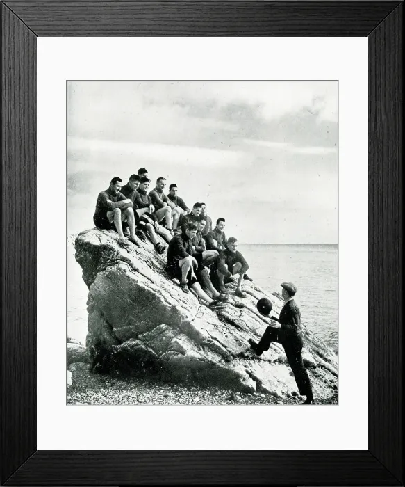 Framed Print : Torquay United football team on a rock with trainer Jones
