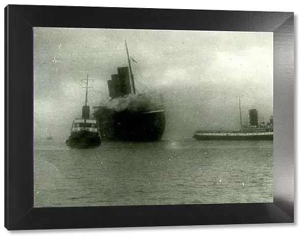 L'Atlantique liner towed into Cherbourg harbour