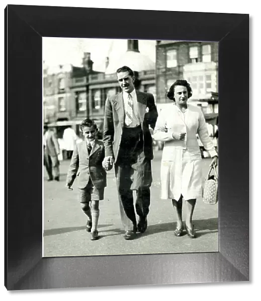 Family of three walking in the street