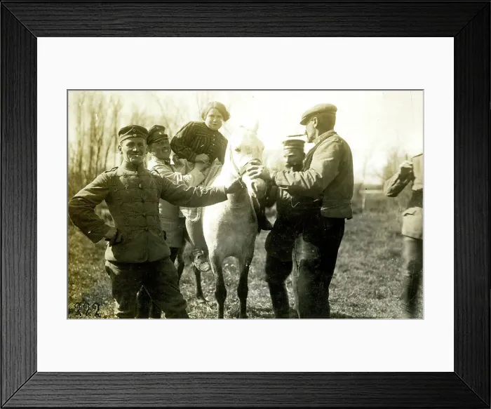 Framed Print : German soldiers help farmer's wife onto a horse, WW1 Framed Print : German soldiers help farmer's wife onto a horse, WW1