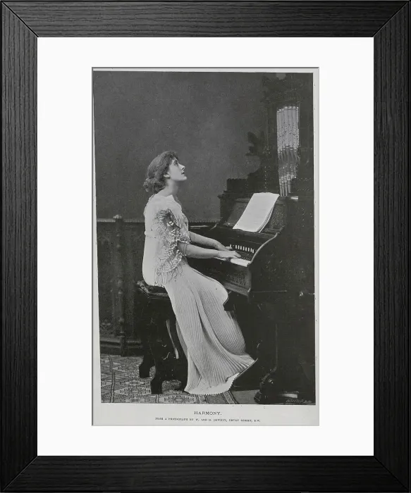 Framed Print : Woman seated at keyboard of a pipe organ, studio portrait Framed Print : Woman seated at keyboard of a pipe organ, studio portrait