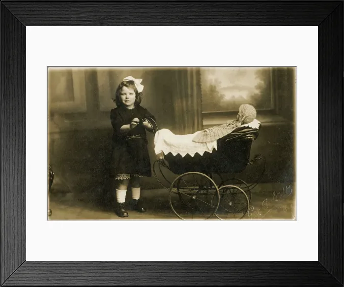 Framed Print : Young girl taking her dolly out in a fine perambulator Framed Print : Young girl taking her dolly out in a fine perambulator