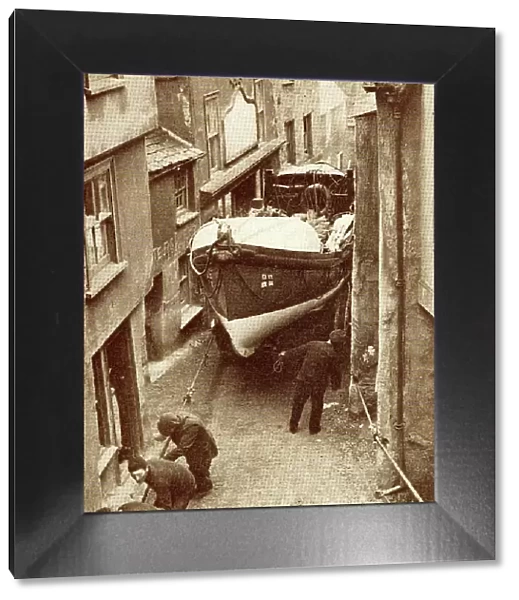 Hauling the lifeboat through a narrow street