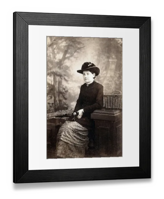 Framed Print : Studio photo, Seated woman with painted backdrop Framed Print : Studio photo, Seated woman with painted backdrop