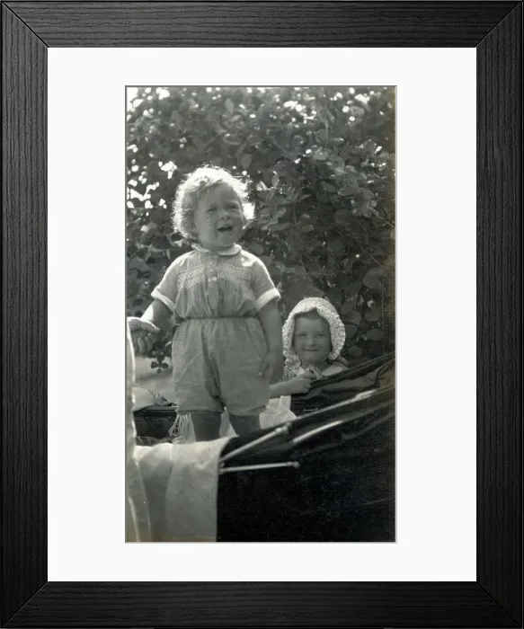 Framed Print : Two young siblings, one standing in a fine baby carriage Framed Print : Two young siblings, one standing in a fine baby carriage