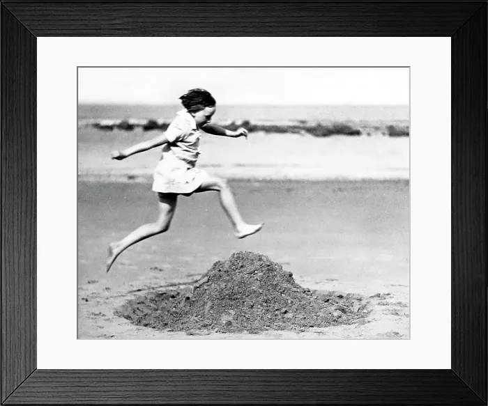 Framed Print : Girl playing on the beach, early 1900s Framed Print : Girl playing on the beach, early 1900s