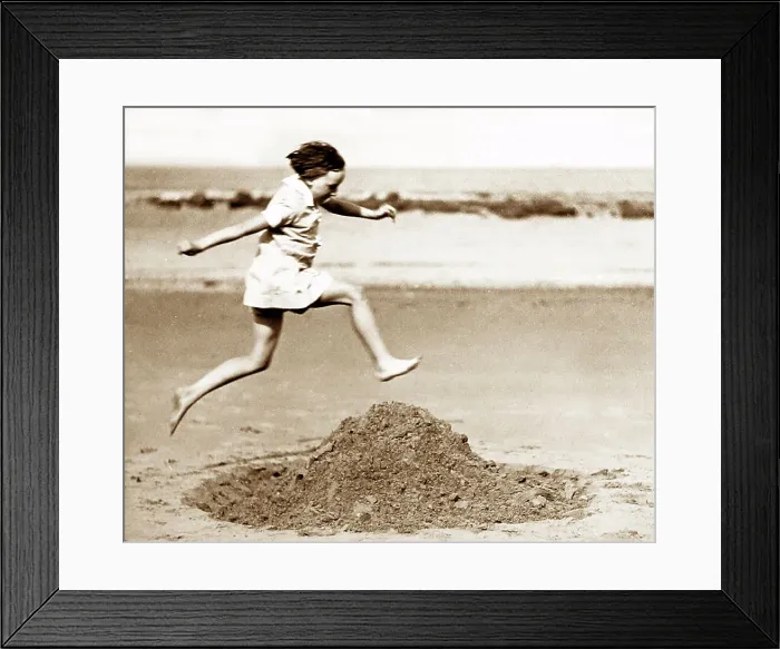 Framed Print : Girl playing on the beach, early 1900s Framed Print : Girl playing on the beach, early 1900s
