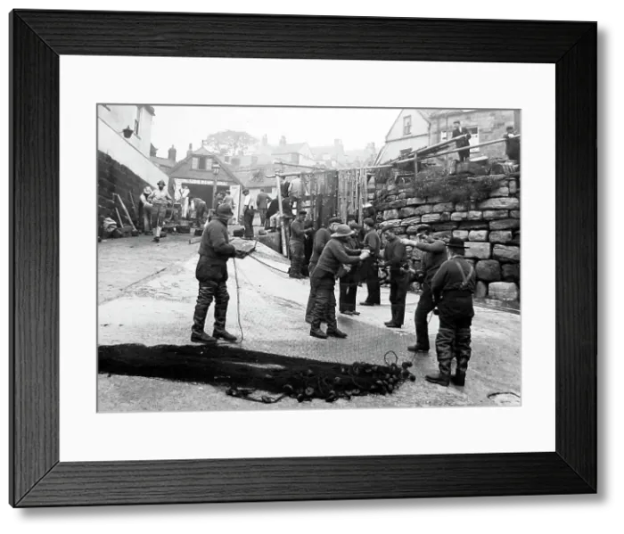 Framed Print : Robin Hoods bay repairing the nets Framed Print : Robin Hoods bay repairing the nets