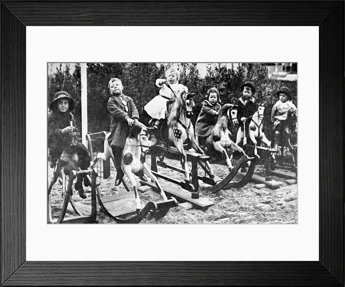 Framed Print : Children playing on rocking horses Framed Print : Children playing on rocking horses