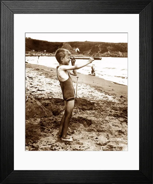 Framed Print : Boy on a beach with a telescope Framed Print : Boy on a beach with a telescope