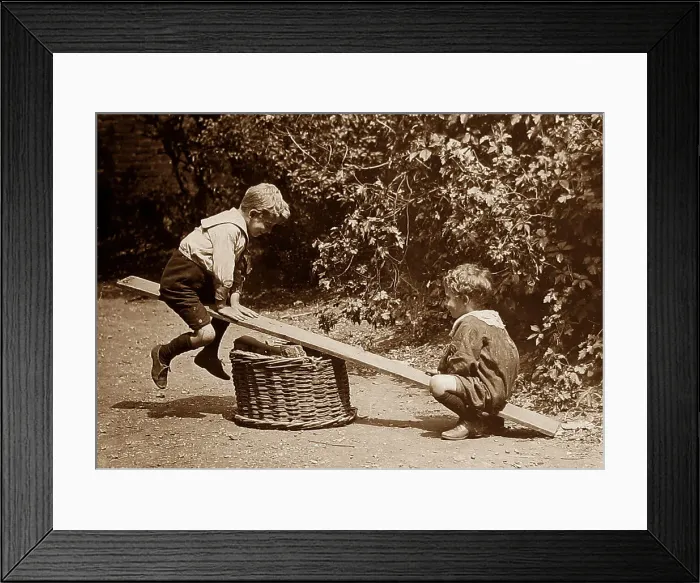 Framed Print : Children playing on a seesaw Framed Print : Children playing on a seesaw