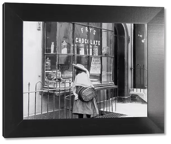 Girl looking in sweet shop window Victorian period