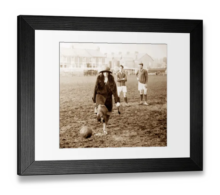 Framed Print : A lady kicking a football, early 1900s Framed Print : A lady kicking a football, early 1900s