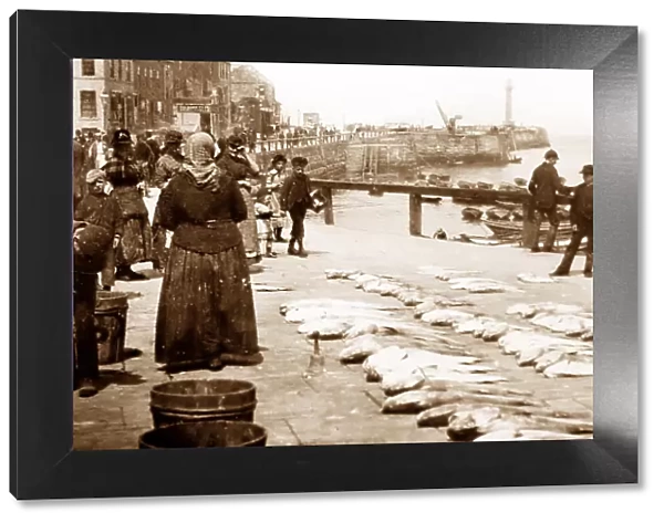 A fishwife selling fish on the quayside, Victorian period