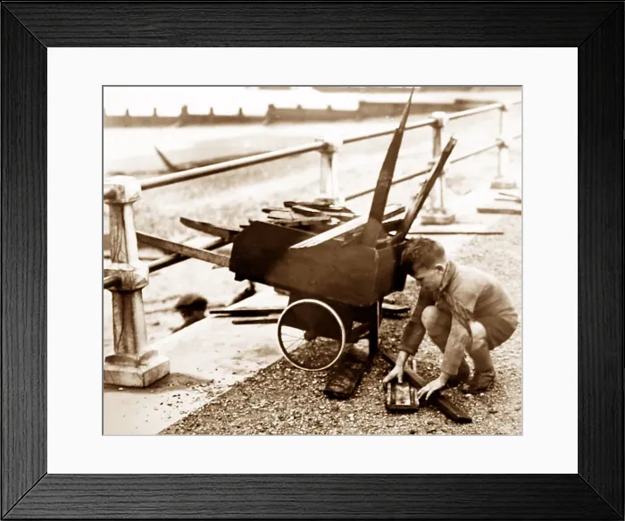 Framed Print : Boy collecting driftwood at seaside, 1930s Framed Print : Boy collecting driftwood at seaside, 1930s