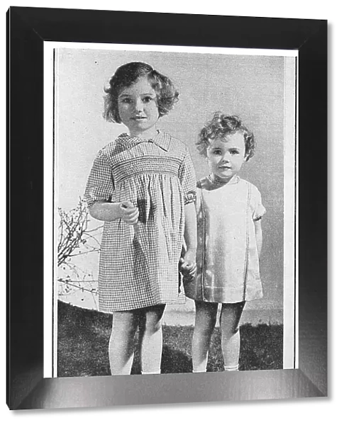 Two child models wearing smocked dresses. Date: 1935