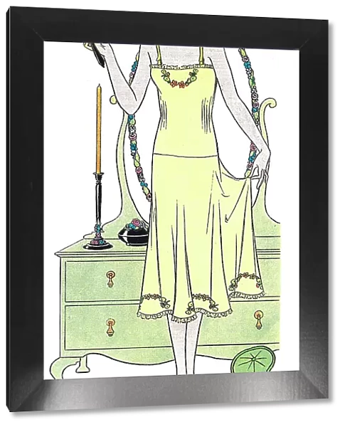 Illustration of a lady in her bedroom admiring her embroidered petticoat in crepe-de-chine Date: 1931