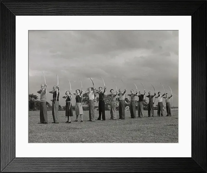 Framed Print : Archery - toxophilites line up, illustrating the correct way to hold the Long Bow, the Wirral, Cheshire, England. Date: 1930s Framed Print : Archery - toxophilites line up, illustrating the correct way to hold the Long Bow, the Wirral, Cheshire, England. Date: 1930s