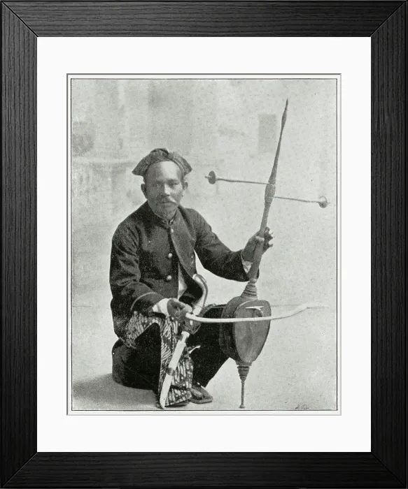 Framed Print : Indonesian man playing his rehab fiddler. Date: early 1890s Framed Print : Indonesian man playing his rehab fiddler. Date: early 1890s