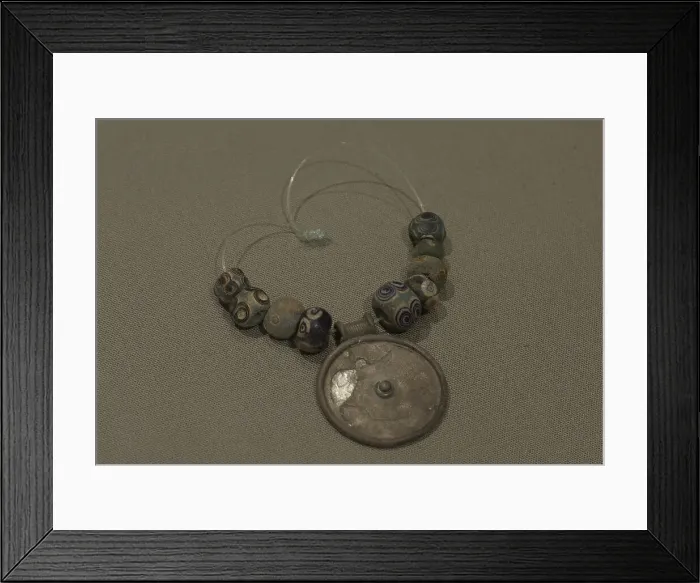 Framed Print : Silver medallion and faience eye beads Framed Print : Silver medallion and faience eye beads