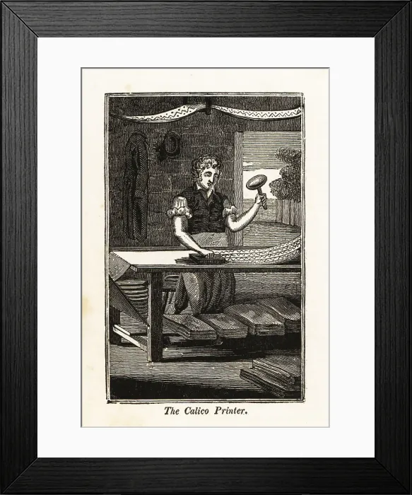 Framed Print : Calico-printer printing fabric with a woodblock in an atelier Framed Print : Calico-printer printing fabric with a woodblock in an atelier