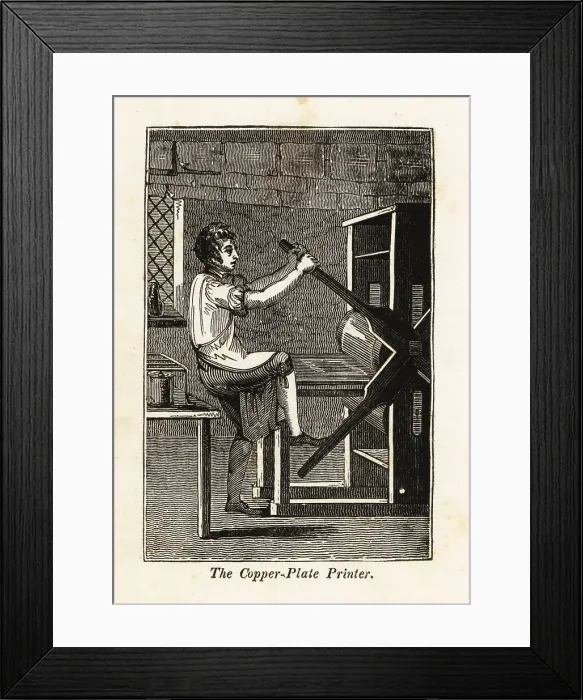 Framed Print : Copperplate printer pulling on a press in a printshop Framed Print : Copperplate printer pulling on a press in a printshop