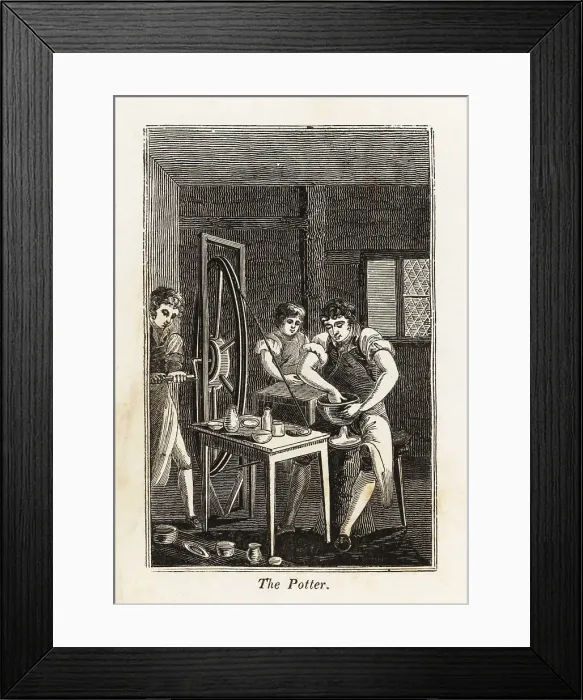 Framed Print : Potter in apron shaping a clay bowl in a workshop Framed Print : Potter in apron shaping a clay bowl in a workshop