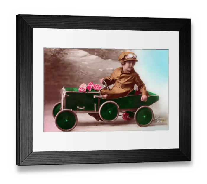 Framed Print : Young French girl driving her green pedal car Framed Print : Young French girl driving her green pedal car