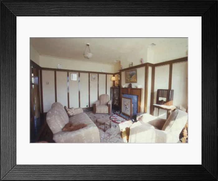 Framed Print : A typical living room or front reception room, with a picture rail, tapestry firescreen, Bakelite radio, display cabinet and three piece suit. Date: 1940s (re-enactment) Framed Print : A typical living room or front reception room, with a picture rail, tapestry firescreen, Bakelite radio, display cabinet and three piece suit. Date: 1940s (re-enactment)
