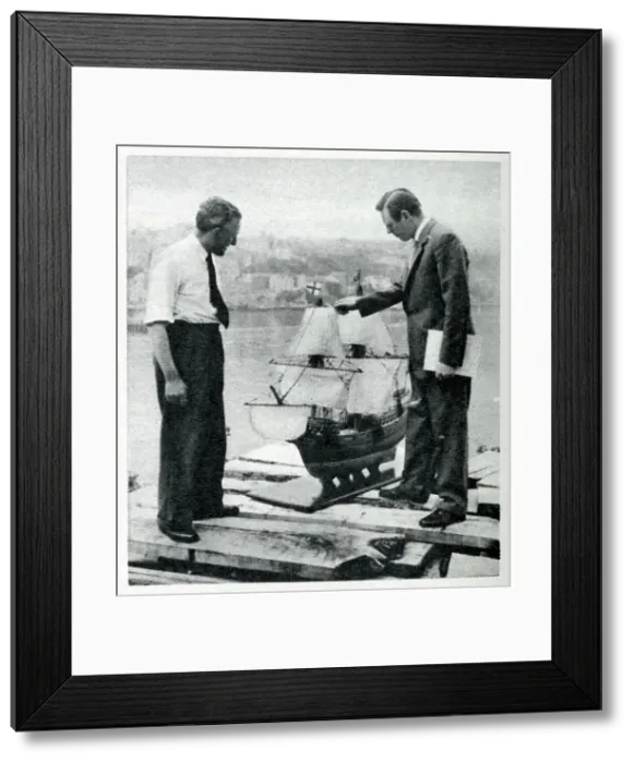 Framed Print : Upham and Charlton inspect a scale model of the Mayflower II, built in the 1950s as an exact replica of the original Mayflower ship. Date: 1956
