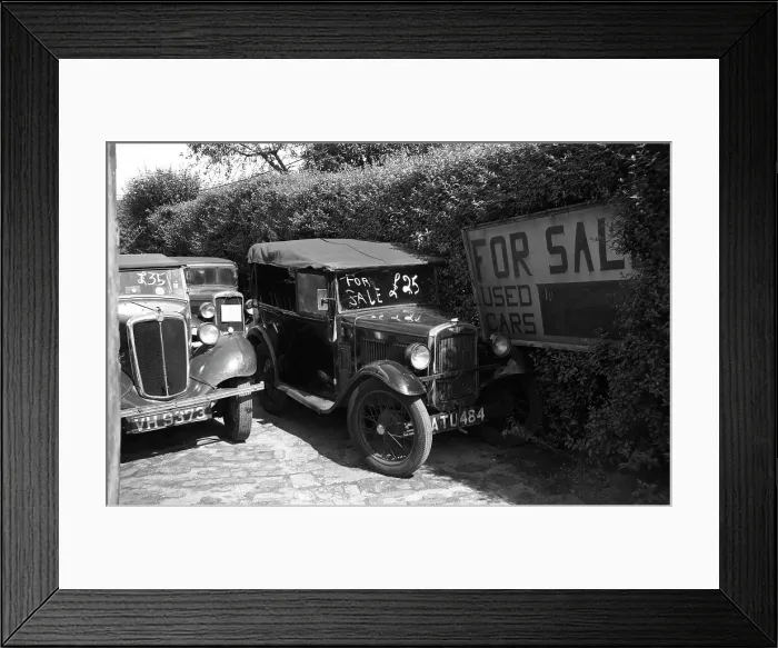 Framed Print : Two used cars for sale including a Morris Eight (left) and an Austin seven AJ tourer (right). Date: circa 1950s Framed Print : Two used cars for sale including a Morris Eight (left) and an Austin seven AJ tourer (right). Date: circa 1950s