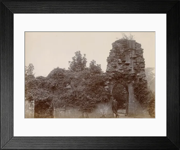 Framed Print : Ruined medieval building, North Wales, with man leaning in open doorway Date: circa 1889 Framed Print : Ruined medieval building, North Wales, with man leaning in open doorway Date: circa 1889