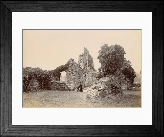 Framed Print : Ruined medieval building, North Wales, with smartly dressed seated man Date: circa 1889 Framed Print : Ruined medieval building, North Wales, with smartly dressed seated man Date: circa 1889
