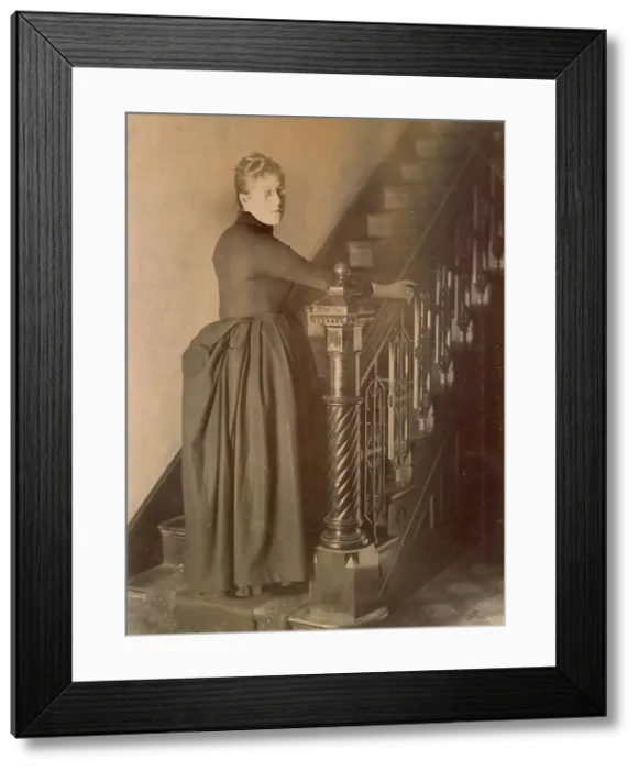 Framed Print : Woolfe family of The Clough, Hale, Bucklow, Cheshire - possibly Lucy, at the foot of a staircase in her home, The Clough. (1 of 2) Date: 1889 Framed Print : Woolfe family of The Clough, Hale, Bucklow, Cheshire - possibly Lucy, at the foot of a staircase in her home, The Clough. (1 of 2) Date: 1889