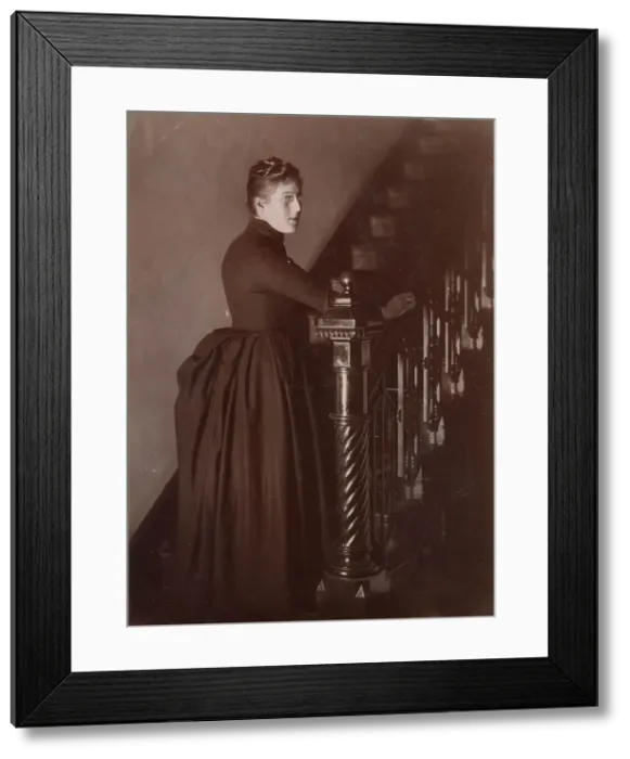 Framed Print : Woolfe family of The Clough, Hale, Bucklow, Cheshire - possibly Lucy, at the foot of a staircase in her home, The Clough. (2 of 2) Date: 1889 Framed Print : Woolfe family of The Clough, Hale, Bucklow, Cheshire - possibly Lucy, at the foot of a staircase in her home, The Clough. (2 of 2) Date: 1889