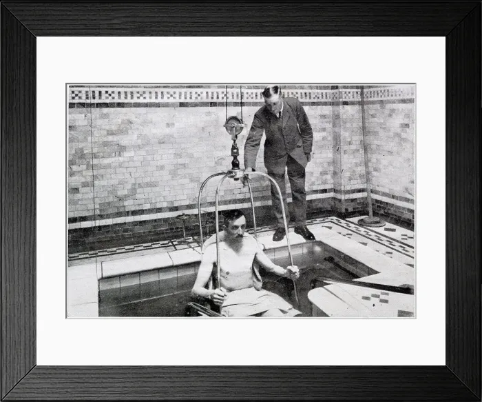Framed Print : A man been lowered by crain into a bath of hundreds of gallon of radio-active water, for treatment for diseases such as tuberculosis, in Bath, Somerset Framed Print : A man been lowered by crain into a bath of hundreds of gallon of radio-active water, for treatment for diseases such as tuberculosis, in Bath, Somerset