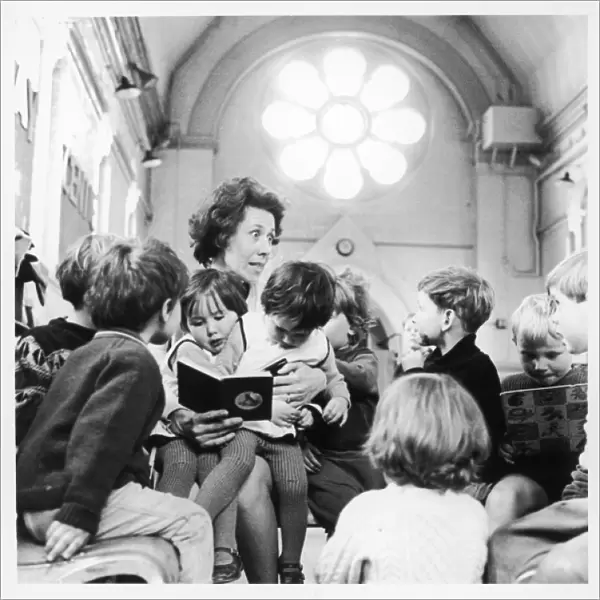 Teacher reading to infants, Brentwood, Essex
