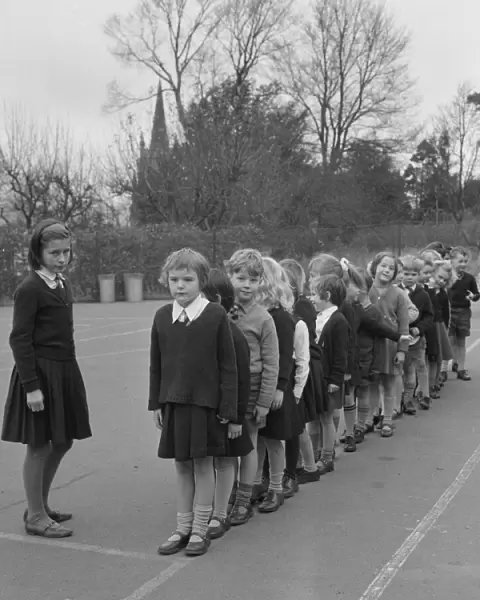Schoolchildren line up in playground