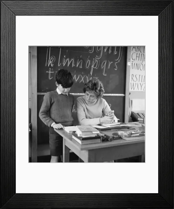 Framed Print : Pupil reading with teacher Framed Print : Pupil reading with teacher