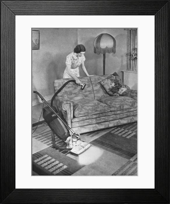 Framed Print : Woman hoovering Framed Print : Woman hoovering