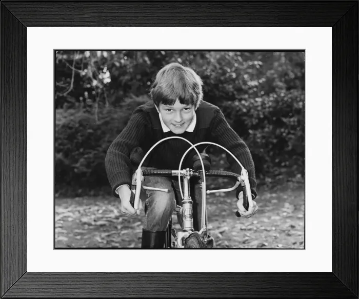 Framed Print : BOY RACER. A smiling boy leaning on the handlebars of his racing bike Framed Print : BOY RACER. A smiling boy leaning on the handlebars of his racing bike