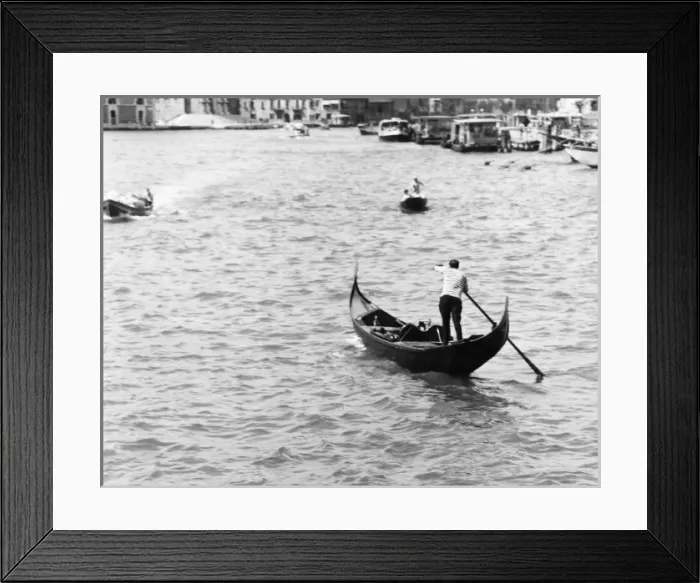 Framed Print : A GONDOLA. A gondola makes its way through the waterways of Venice Framed Print : A GONDOLA. A gondola makes its way through the waterways of Venice