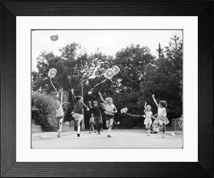 Framed Print : Children race down the street with kites Framed Print : Children race down the street with kites