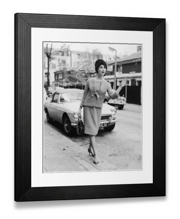 Framed Print : TAXI. A woman in smart stylish suit of straight knee-length skirt Framed Print : TAXI. A woman in smart stylish suit of straight knee-length skirt