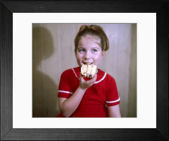 Framed Print : Girl Eats a Cake 1960S Framed Print : Girl Eats a Cake 1960S