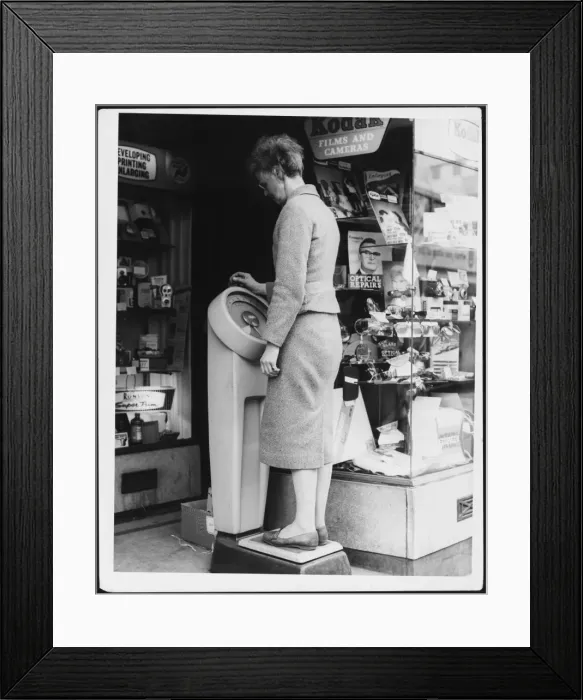 Framed Print : Woman Weighing Herself Framed Print : Woman Weighing Herself