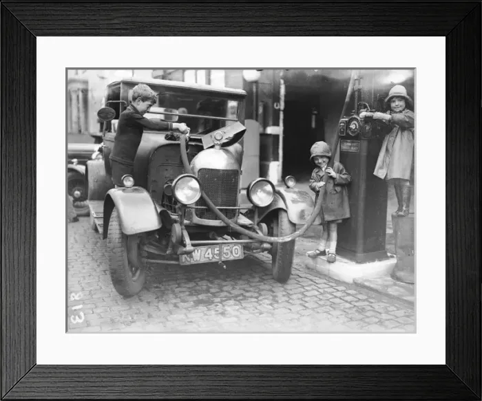 Framed Print : Kids Refuelling a Car Framed Print : Kids Refuelling a Car